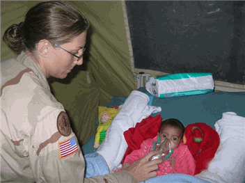 Photo: BU GHRAIB, Iraq (Oct. 30, 2005) - Maj. Lisa Flynn MD provides oxygen to Tabark Addul Rahman, aka Baby Tabitha. Flynn the general and vascular surgeon for the hospital at Abu Ghraib was primary physician for the baby. Photo by Maj. Brad Wenstrup 344th Combat Support Hospital.