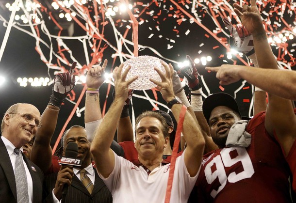Alabama Crimson Tide head coach Saban holds up the trophy after his