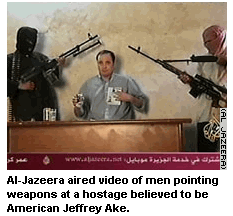 Photo: Al-Jazeera aired video of men pointing weapons at a hostage believed to be American Jeffrey Ake.