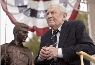 Photo Andy Griffith sits in front of a bronze statue of Andy and Opie from the 'Andy Griffith Show,' Tuesday, Oct. 28, 2003, after the statue was unveiled during a ceremony in Raleigh, N.C. Griffith's 40-year acting career has been largely defined by Sheriff Andy Tayor, who he played in the show. (AP Photo/Bob Jordan)