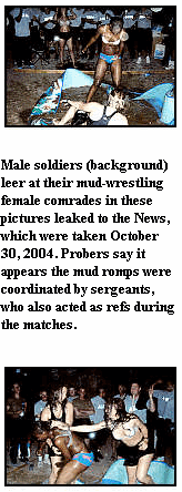 Photo: Male soldiers (background) leer at their mud-wrestling female comrades in these pictures leaked to the News, which were taken October 30, 2004. Probers say it appears the mud romps were coordinated by sergeants, who also acted as refs during the matches. 