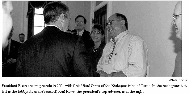 President Bush shaking hands in 2001 with Chief Raul Garza of the Kickapoo tribe of Texas. In the background at left is the lobbyist Jack Abramoff; Karl Rove, the president's top adviser, is at the right.