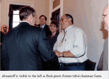 Abramoff is visible to the left as Bush greets former tribal chairman Garza