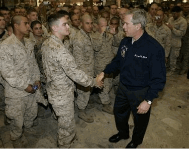 Photo U.S. President George W. Bush greets U.S. Marines from the 7th Marine Division on their way to Kuwait during Bush's refueling stop in Shannon, Ireland, Wednesday, March 1, 2006. (AP Photo/Charles Dharapak)