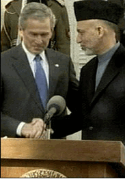 Photo President Bush shaking hands with President Karzai during a joint news conference.