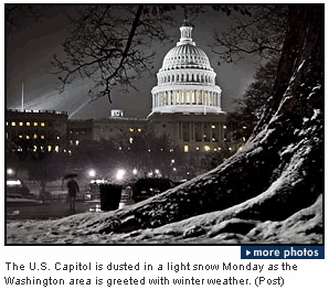 Photo The U.S. Capitol is dusted in a light snow Monday as the Washington area is greeted with winter weather