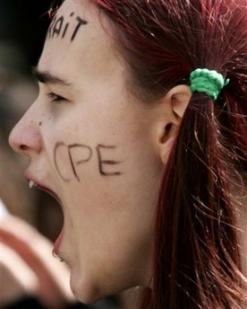 Photo: A demonstrator shouts as unionist and students demonstrate against the French government's labor laws in Paris Tuesday April 4, 2006. On her face reads: withdraw the CPE, the new job contract.(AP Photo/Francois Mori)