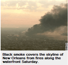 Photo: Black smoke covers the skyline of New Orleans from fires along the waterfront Saturday.