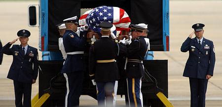 A casket containing the body of former President Reagan is loaded by a military honor guard into a lift truck at Andrews Air Force Base Md., Friday June 11, 2004. Reagan's body will return to California for burial. (AP Photo/Steve Helber)