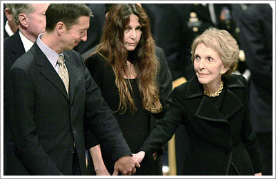Alongside daughter Patti Davis, Nancy Reagan reaches out to son Ron Jr. following today's state funeral at the National Cathedral. (Reuters)