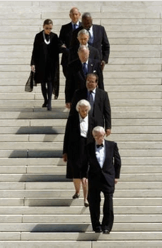 Supreme Court justices (From bottom right to top left) John Paul Stevens, Sandra Day O'Connor, Antonin Scalia, Anthony Kennedy, David Souter, Clarence Thomas, Stephen Breyer and Ruth Bader Ginsburg descend the steps of the Supreme Court in Washington, D.C., September 7, 2005. The justices waited at a hearse at the bottom of the steps for the casket of the late Chief Justice William Rehnquist. REUTERS/Jonathan Ernst
