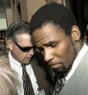 Photo R&B star R. Kelly, right, is read his rights by a Chicago police investigator Dan Everett, left, as he is arrested Friday, June 7, 2002, in Chicago. Singer R. Kelly is a step closer to trial after a judge refused Friday Oct. 28, 2005 to dismiss charges in a three-year old case against him for allegedly engaging in videotaped sex acts with an underage girl. Kelly has pleaded not guilty to 14 counts of child pornography. (AP Photo/Stephen J. Carrera)
