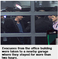Photo: Evacuees from the office building were taken to a nearby garage where they stayed for more than two hours.