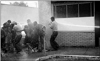 Photo: May 3-9, 1963: Youths are pummeled by water from a fire hose during a Children's Crusade demonstration in downtown Birmingham.
