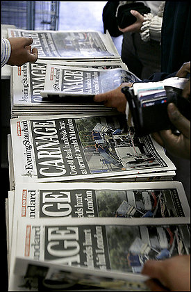 A London tabloid proclaiming 'Carnage' about attacks on British trains is snapped up by commuters. 'Both the media and terrorists benefit from terrorist incidents,' concludes a recent study. The terrorists get publicity and the media gain circulation and profits. Photo Credit: By Matt Dunham -- Associated Press
