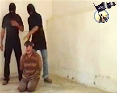 Russian Diplomats Murdered In this image made from a Web video taken at an unknown location, two masked men prepare to apparently kill a kneeling blindfolded employee of the Russian embassy in Iraq . The identity of the man cannot be accurately discerned. An al-Qaida-linked group posted the Web video Sunday June 25, 2006, showing the killings of three Russian embassy workers abducted earlier this month in Iraq. A fourth also was said to have been killed. Footage of the men speaking into the camera is dated June 13, but the footage of the killings is undated. Arabic script on al-Qaida emblem at top right reads: 'There is no god except Allah.' [AP Photo]