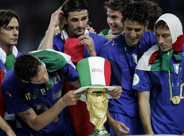 Italy Beats France for 2006 World Cup Title Photo taly's Marco Materazzi puts on a hat on the trophy as Fabio Grosso, second from right, and Francesco Totti, right, look on at the end of the final of the soccer World Cup match between Italy and France in the Olympic Stadium in Berlin, Sunday, July 9, 2006. (AP Photo/Thomas Kienzle)