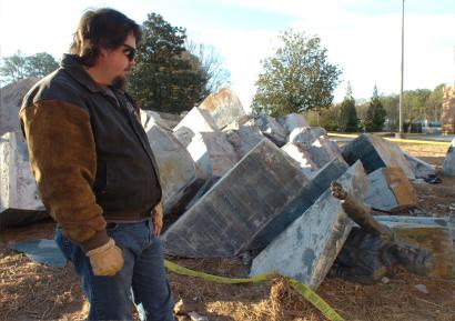 Spaceship Earth Sculpture Photo: AFTER: Kennesaw State University employee John Kirtley examines a pile of rubble that was once the sculpture 'Spaceship Earth.' It collapsed last Thursday during campus holiday break.