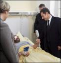 Sarkozy Vows to Punish Gun-Toting Rioters Nicolas Sarkozy (R) and Michele Alliot-Marie visit a police officer who was injured during clashes with rioters ©AFP/Pool - Thomas Coex