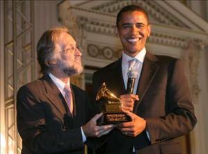 Obama Beats Clinton at Grammys U.S. Senator Barack Obama (D-IL) (R) poses with his Grammy awarded to him by Grammy President Neil Portnow during a 'Grammys on the Hill' event on Capitol Hill in Washington September 6, 2006.  REUTERS/Molly Riley  (UNITED STATES)