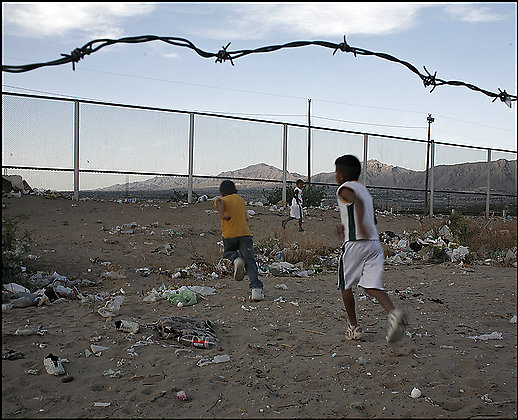 Border Fence Mexico Three boys in Mexico run toward the fence that marks the U.S. border near El Paso. On the other side is a field where children often play soccer. Photo Credit: By Sarah L. Voisin -- The Washington Post