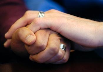 Gay Marriage Photo Stuart Gaffney, left, and John Lewis, right, embrace hands with their wedding bands on in San Francisco on Friday, June 30, 2006. More California voters now support allowing same-sex marriage than oppose it, according to a new poll released Wednesday, May 28, 2008. (AP Photo/Benjamin Sklar)