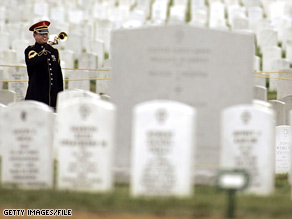 U.S. Army bugler plays taps during burial services for a female soldier at Arlington National Cemetery in 2005.