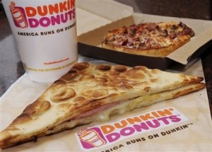 In this Feb. 12, 2008 file photo a flatbread sandwich, personal pizza and coffee are see in a Dunkin' Donuts franchise in Boston. Looking to entice those hungry for a healthier option, Dunkin' Donuts will begin offering a new slate of better-for-you offerings in August. The menu, which will debut in stores Aug. 6, will feature two new flatbread sandwiches made with egg whites. Customers will be able to choose either a turkey sausage egg-white sandwich or a vegetable one. Both will be under 300 calories with 9 grams of fat or less, the company said.