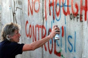 Pink Floyd co-founder Roger Waters spray-paints the words 