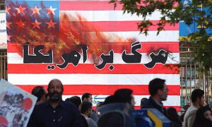 Iranians pass a US flag with a sign reading 'Death to America' as they attend a rally in Tehran, in 2004. Photograph: Hasan Sarbakhshian/AP