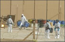 In a Monday June 9, 2003 file photo, UN inspectors from the International Atomic Energy Agency (IAEA) work at the nuclear facility in Tuwaitha, Iraq, 50 kms east of Baghdad. The last major remnant of Saddam Hussein's nuclear program - a huge stockpile of concentrated natural uranium - reached a Canadian port Saturday, July 5, 2008, to complete a secret U.S. operation that included a two-week airlift from Baghdad and a ship voyage crossing two oceans. (AP Photo/Saurabh Das, file) 