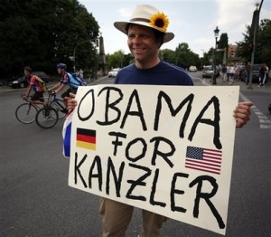 A supporter of U.S. Democratic presidential candidate Sen. Barack Obama, D-Ill., holds a poster meaning 'Obama for Chancellor' prior to Obama's speech at the victory column in Berlin Thursday, July 24, 2008. (AP Photo/Miguel Villagran)