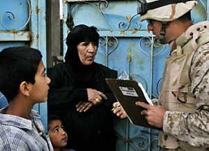 Speaking the same language: An Iraqi-American translator asks census questions in Khandari, Iraq, just west of Baghdad in 2006. Jacob Silberberg/AP/File