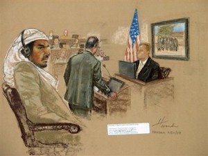 In this Thursday, July 24, 2008 file photograph of a sketch by courtroom artist Janet Hamlin, reviewed by the U.S. Military, defendant Salim Ahmed Hamdan, left, watches as FBI agent Craig Donnachie testifies about his interrogations of Hamdan, while a picture of disguised U.S. agents is displayed on a screen, during Hamdan's trial inside the war crimes courthouse at Guantanamo Bay U.S. Naval Base, in Cuba. A jury of six military officers reached a split verdict on Wednesday, Aug. 6, 2008, in the war crimes trial of Salim Ahmed Hamdan, clearing him of some charges but convicting him of others that could send him to prison for life. The judge scheduled a sentencing hearing for later Wednesday. (AP Photo/Janet Hamlin, Pool)