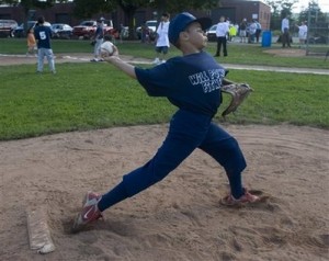 Jericho Scott, 9, warms up on the pitching mound in New Haven, Conn. Saturday Aug. 23, 2008. Officials with the Youth Baseball League of New Haven say they will disband Scott's team because his coach won't stop him from pitching. They say his hard throws may frighten other players in the baseball league for beginners. (AP Photo/Douglas Healey).