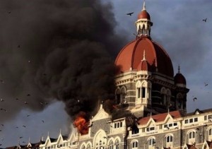 Flames and smoke gush out of the historic Taj Mahal Hotel in Mumbai.Indian army commandos were Thursday battling heavily-armed Islamist gunmen who launched coordinated attacks against luxury hotels and other targets in Mumbai, killing at least 100 people. (AFP/Indranil Mukherjee)