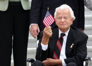 In this Sept. 11, 2008 file photo, Sen. Robert Byrd, D-W.Va, waves a flag during a ceremony on Capitol Hill in Washington in remembrance of the Sept. 11 terrorists attacks. Byrd, the longest-serving senator in history, is stepping down from his cherished post as chairman of the Senate Appropriations Committee. (AP Photo/Lauren Victoria Burke, File)