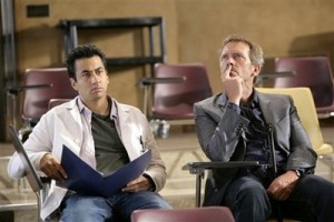 Hugh Laurie, right, and Kal Penn are shown in a scene from the Fox series, 'House.' (AP Photo/FOX, Adam Taylor) 