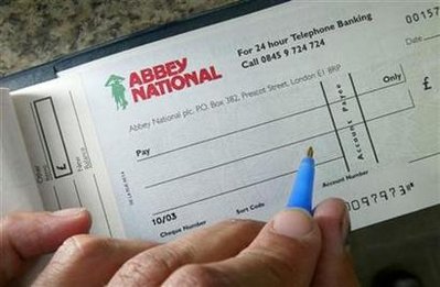 An Abbey National cheque book is pictured in London July 26, 2004. BANKG REUTERS/Toby Melville