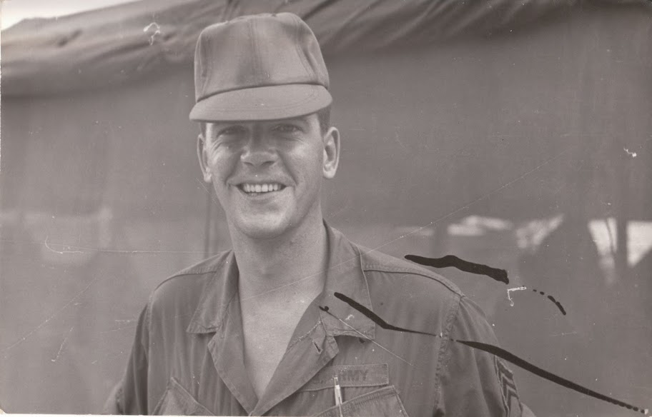 Another rare photo in which he's smiling.  Judging from the uniform and tent, I'd guess Vietnam.