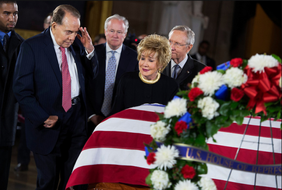  Former Sen. Bob Dole, R-Kan., salutes the casket of the late Sen. Daniel Inouye, D-Hawaii, as his body lies in state in the Capitol rotunda, as Dole's wife, former Sen. Elizabeth Dole, R-N.C., looks on. Bob Dole and Inouye knew each other since they were recovering from World War II battle wounds. Dole was assisted to the casket saying "I wouldn't want Danny to see me in a wheelchair."  (Photo By Tom Williams/CQ Roll Call)